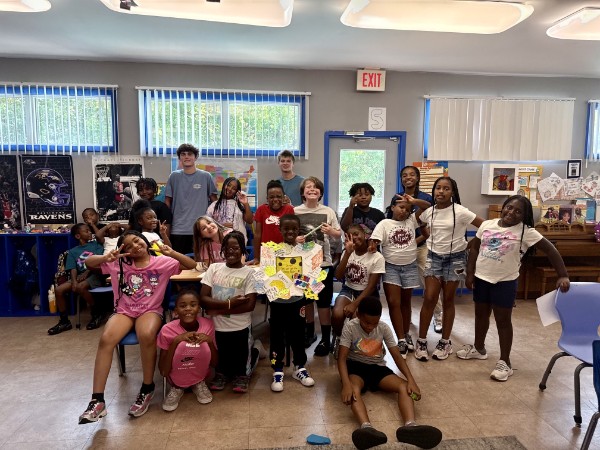 Campers and the book brothers celebrating summer reading program